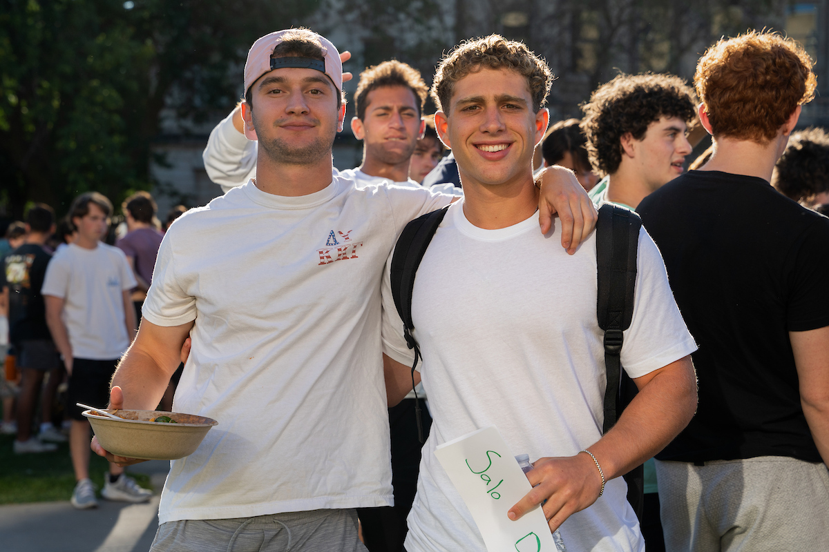 Two students smile at the camera at a school event.