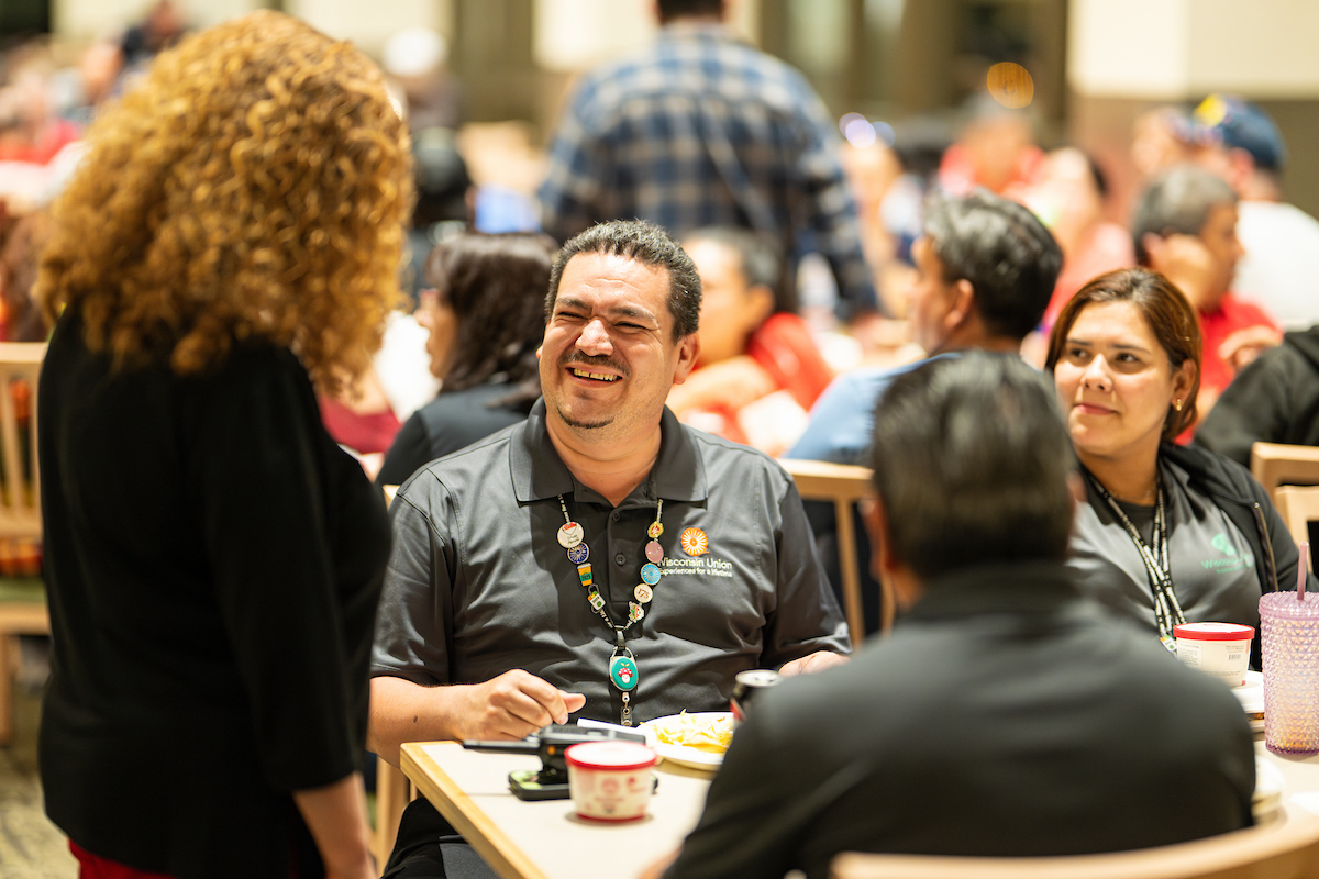 A member of the community smiles at Chancellor Mnookin.