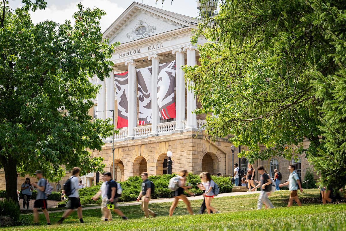 A shot of Bascom Hall with students  walking in front of it. 